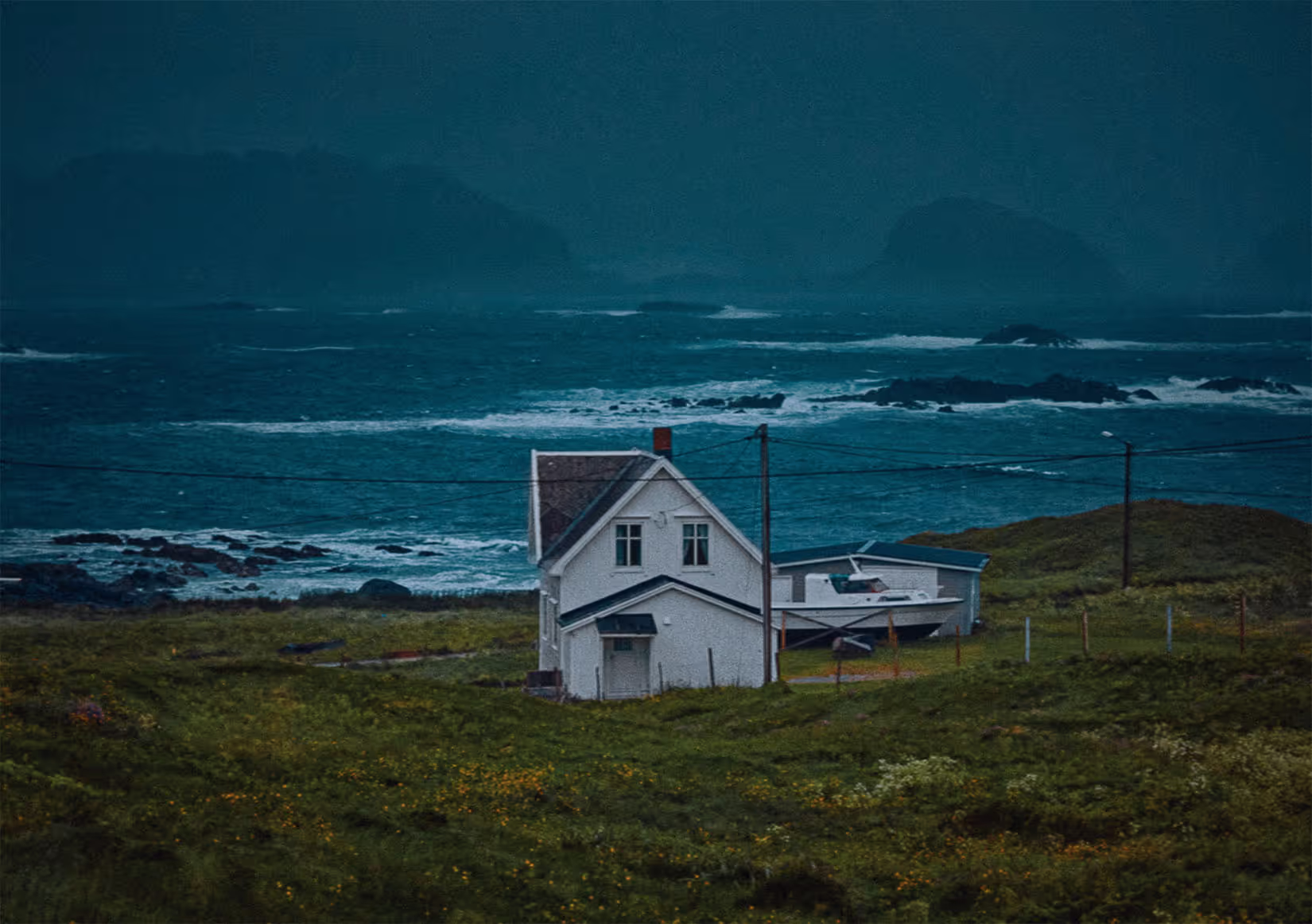 color film photograph of a house on the stormy coast of iceland. deep, vibrant colors, edited with color.io