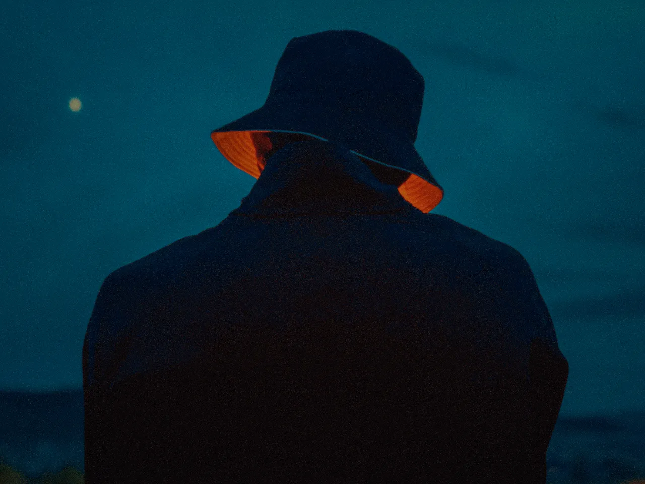 Night scene with tungsten-orange accents and teal shadows, graded with Color.io for a stylized film look.
