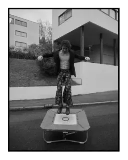 black and white fashion portrait of a man jumping on a trampoline. shot on ilford delta